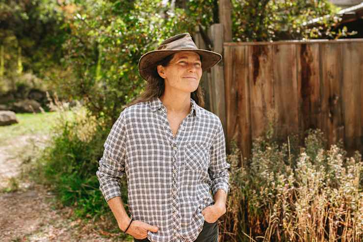 host-in-plaid-by-fence