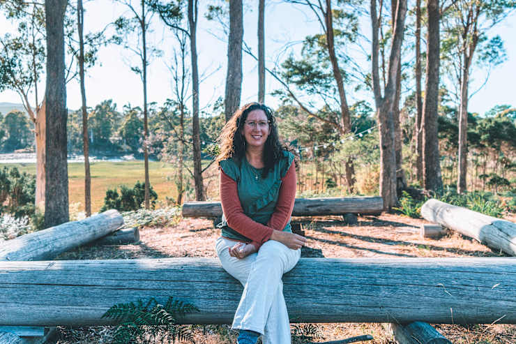 host-sitting-on-log-fence
