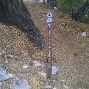 Just before the creek crossing, there's a cluster of signs to point you towards the camp.