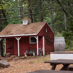 flush toilet, running water, and an available refrigerator in the bathroom and adjacent storage area near the pond