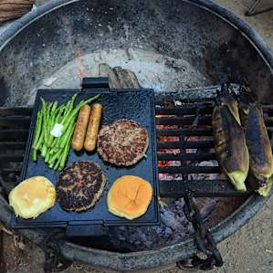 Heavy duty grill grates cover half of each fire pit. A plancha helps to increase the cooking area.