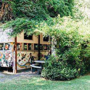 The bus is covered by a lush arbor