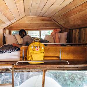 Storage shelf and a big cozy bed with a view