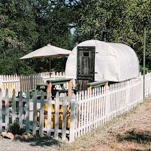 The wagon area is graveled and fenced in.