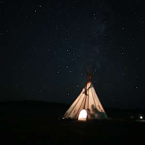 Tipi at midnight, lit by lanterns. We could pull my Jeep right up next to it.