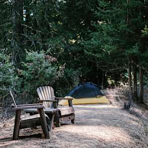 The pond camp isn't too wide but just enough to fit a solo or two person tent next these chairs.
