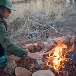 Starting a fire as the sun starts to go down and the temperature drops