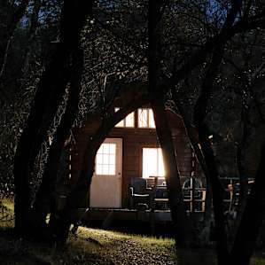 The cozy cabin all lit up.