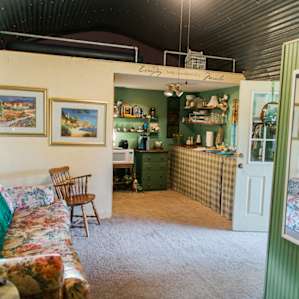 View of living/kitchen area, with lofted area above.