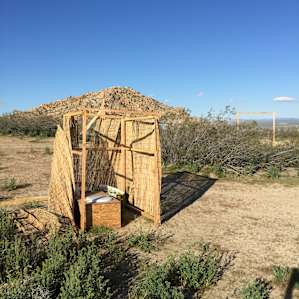 The compost toilet needs the walls fixed