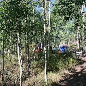 Small campsite with table and fire pit.