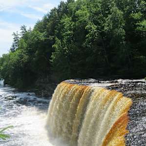 Look past the falls and down the river.