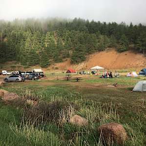 This is basically the whole campground. The river runs behind the sites to the right and the road is to the left .
