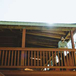 The porch around the perimeter of the cabin is perfect for relaxing and taking in the view of the surrounding forest.