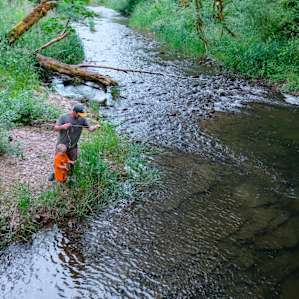 Fishing for crawfish along the peaceful river.