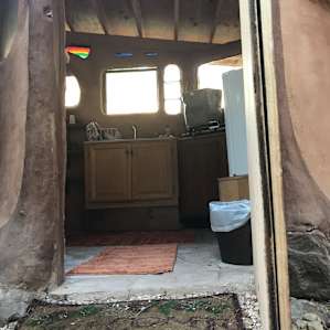 Kitchenette w/silverware, dishes, stove, sink, refrigerator and a kettle