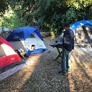 Group of tents within 10 feet of pond