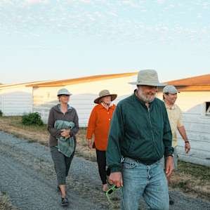 A group of visitors coming back from picking rare seeds in the fields. There are group sessions welcome for this service, in order to protect the local prairie lands.