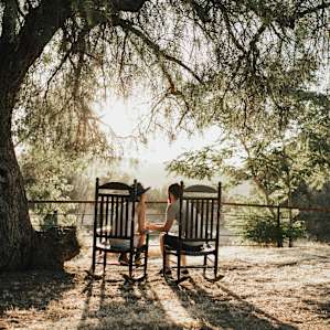 two rocking chairs perfect to sit, relax and take in the sun setting.