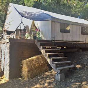 Gorgeous tent with lux comforts like plush bedding and a lofted patio!