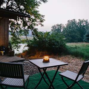 An bistro table and chairs await your leisure.