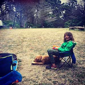 boy and pup, looking out over the grassy area by sites 1-10