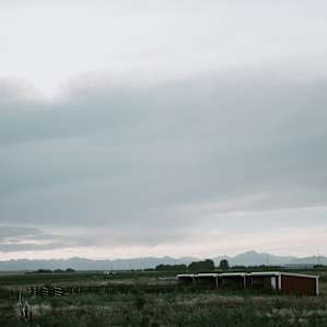 View for days from the camping field. Stream right behind you, mountains in front of you.