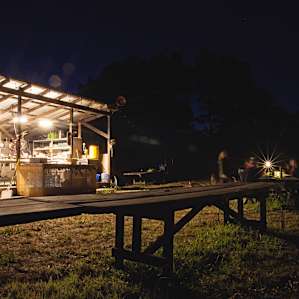 Camp neighbors having dinner together