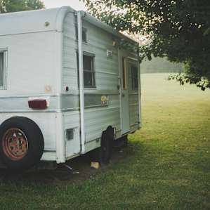 The owner is planning on adding a vintage blue stripe to this small camper. The inside has wallpaper -- a great glamping vehicle!