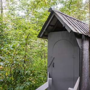 The toilet is just a few steps from the bedroom.