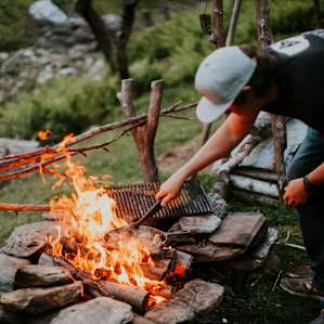 Making dinner by the fire while overlooking the forest valley.