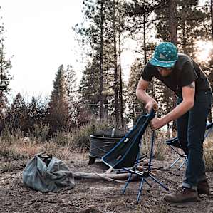 Setting up chairs around the fire.