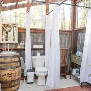 The bathroom is amazing and has a wonderful view of the woods.