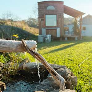 A fountain built by the host next to the tiny house.