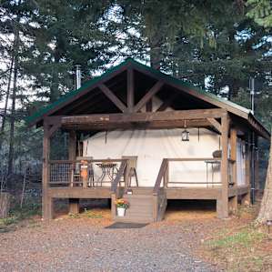 Call it a tent if you want, but this is luxury. Full kitchen, bed, shower, and wood stove inside.