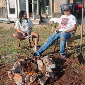 Campers chat around a recently constructed stone fire pit