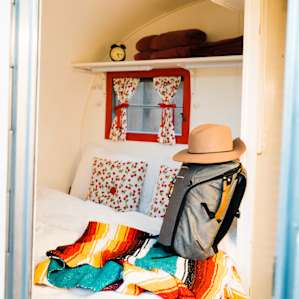 Inside the trailer - comfortable queen bed + extra towels. Bill has thought of everything!