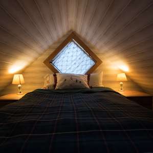 The bed in the loft above the kitchen.
