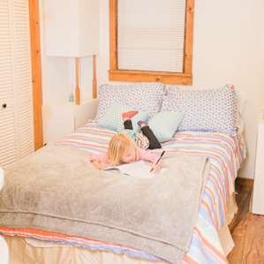 The cabin's comfortable bedrooms invite guests to take a great nap, or catch up on a great book (or color!)