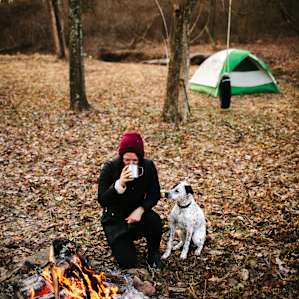 Enjoying a warm cup of coffee at the campsite by the fire on a cold, winter morning.