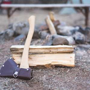 A stone fire pit is surrounded by benches for seating.