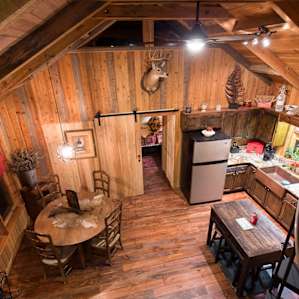 Bird's-eye view of the dining table and kitchen, from up in the loft.