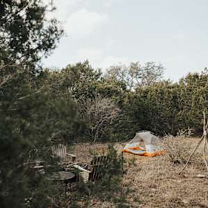 A view of your campsite, with outdoor firepit, firewood, and chairs provided