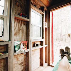 Little trinkets, books, and a few CDs line the walls of this tiny cabin.