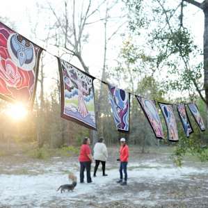 Prayer flags around a fire ring.