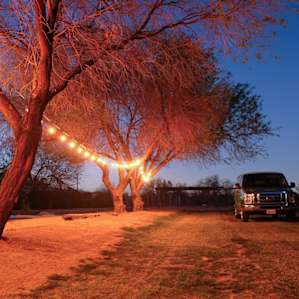 Camping area lit up at night.