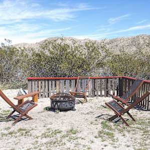 Firepit and chairs provided close to the tent