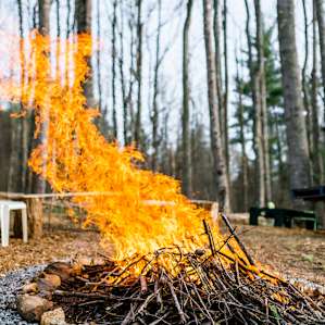 Sit around the fire pit! Many stools and benches are perched right beside it.