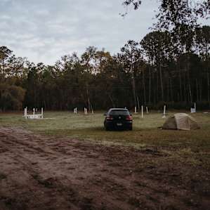 Our tent and car situated in the field