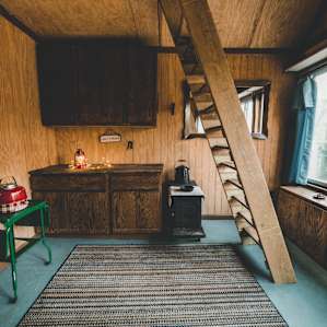 The step ladder will lead to the main sleeping area. The kitchen include numerous cabinets which are great for storage.
